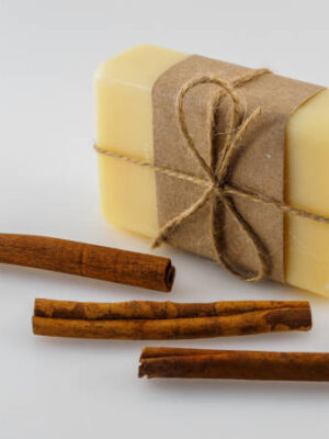 The soap in the wrapper is tied with a bow. cinnamon and soap.