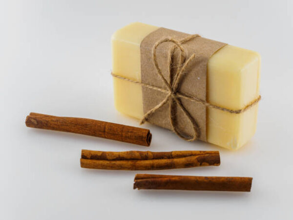 The soap in the wrapper is tied with a bow. cinnamon and soap.