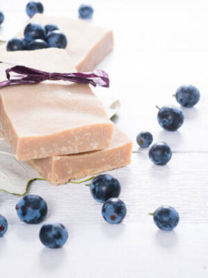 Handmade soaps from red grapes seed oil, on white wood table